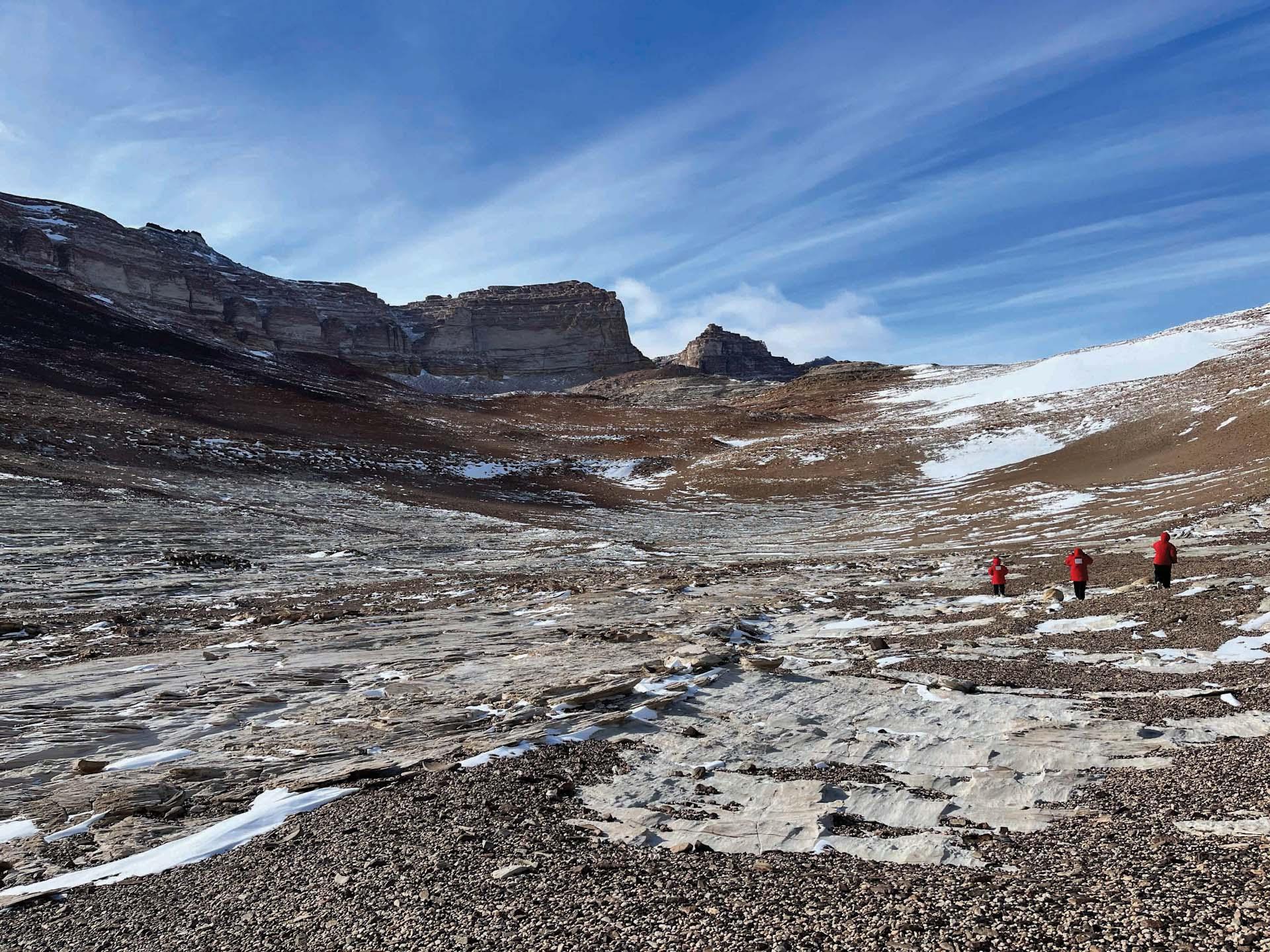 3 scientists in rocky field Antarctica